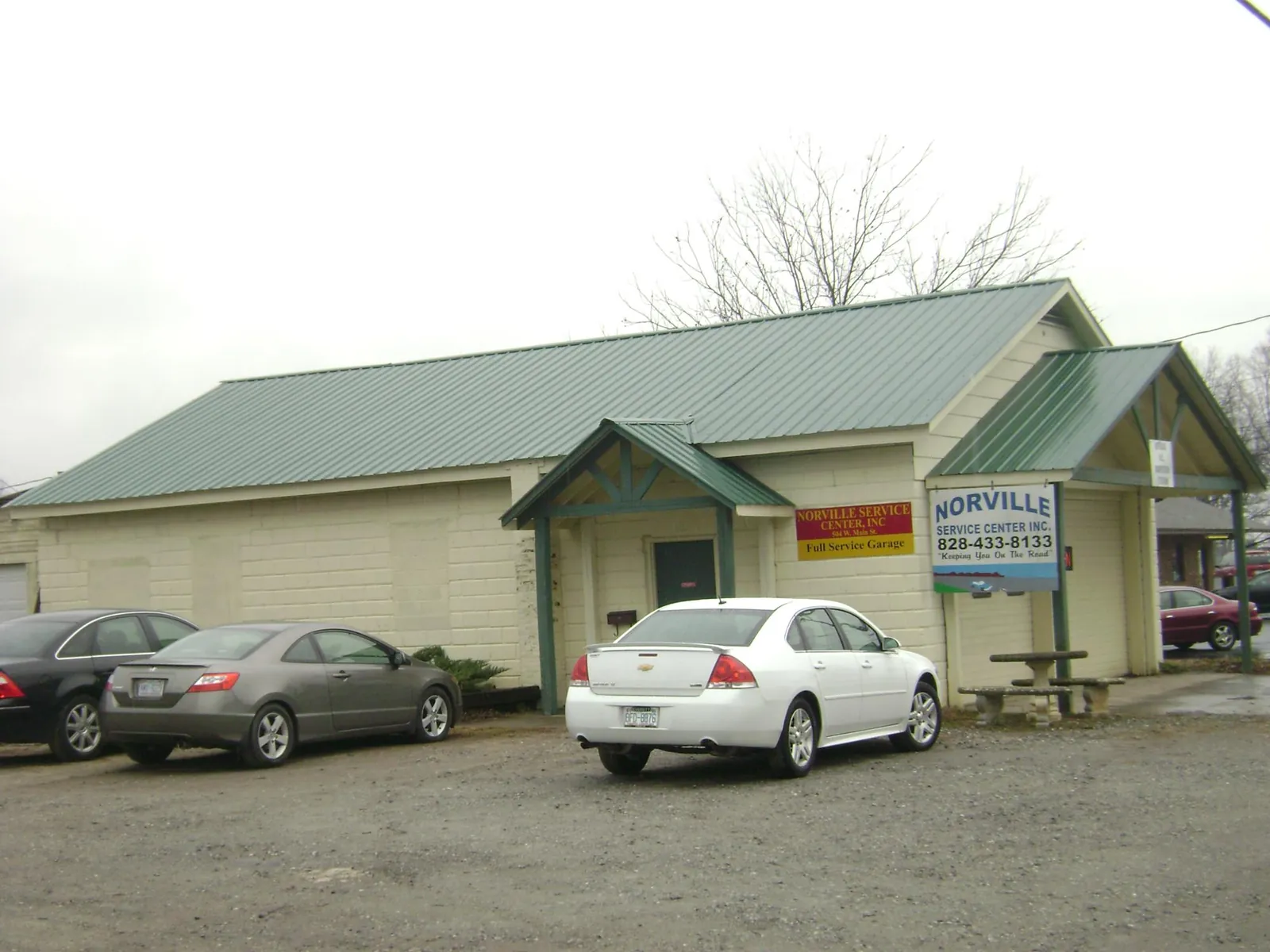 Green metal roof on a service garage with a covered entry in Almira
